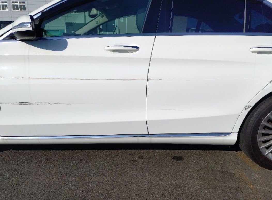 Close-up of scrapes along both left doors