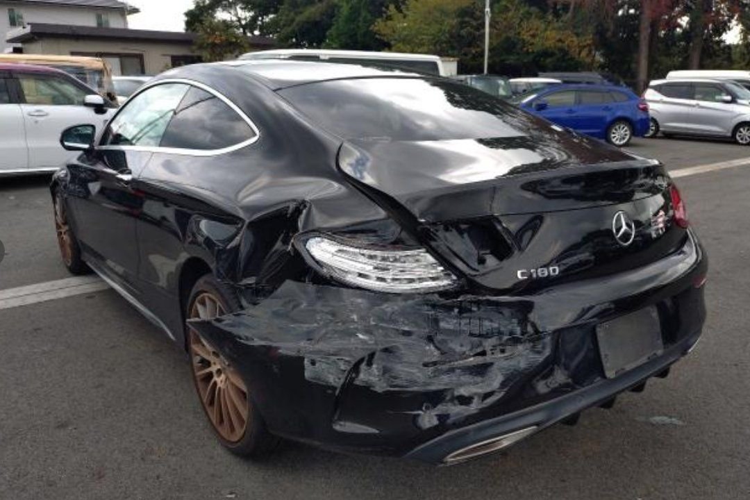 Rear left showing the crushed rear quarter and torn bumper