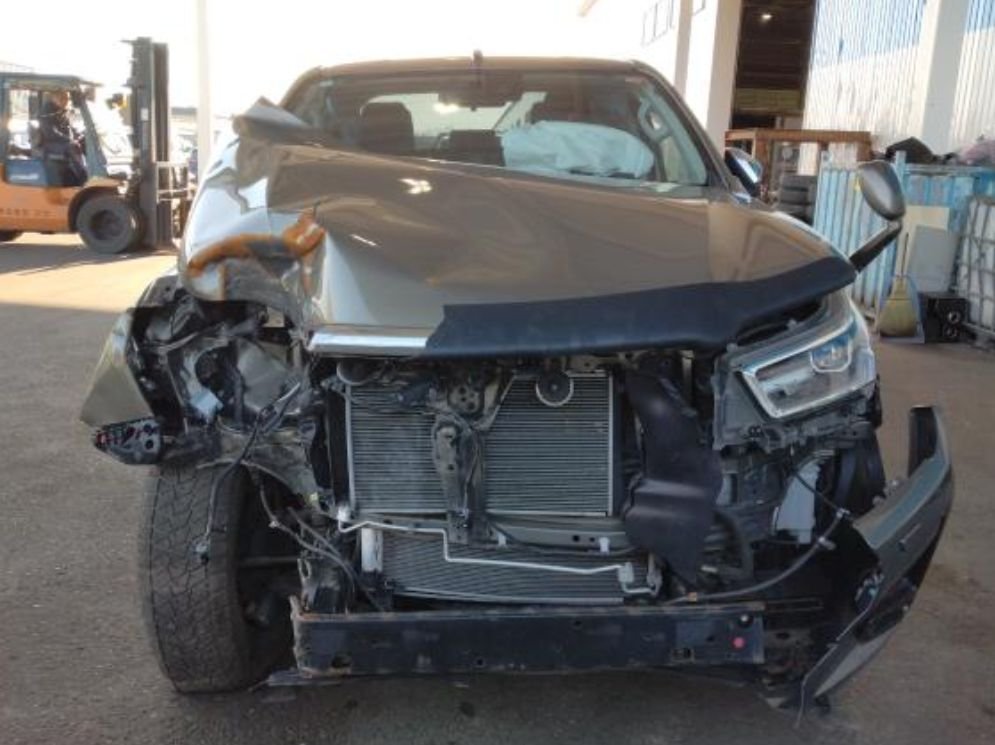 Front of the Hilux with the bumper and grille torn off, radiators exposed