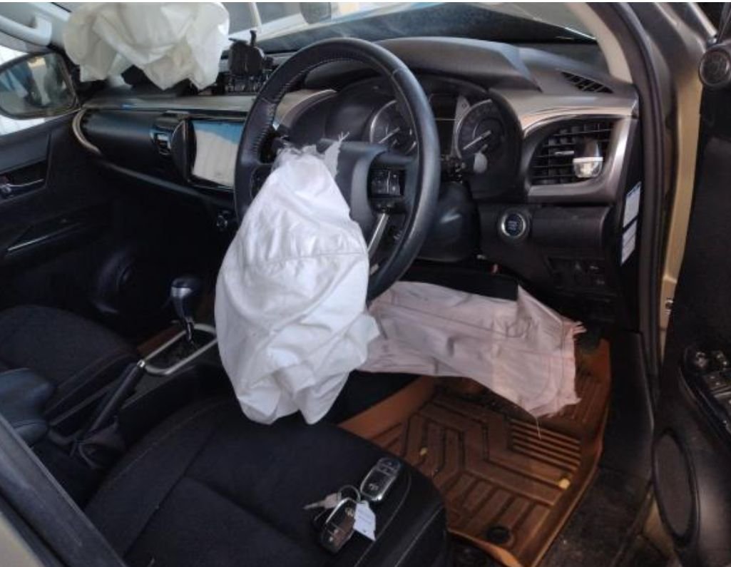 Right-hand-drive cabin with deployed steering wheel and knee airbags