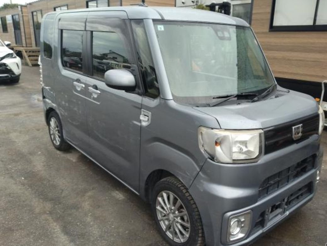 Grey Daihatsu Wake kei car seen from the front right