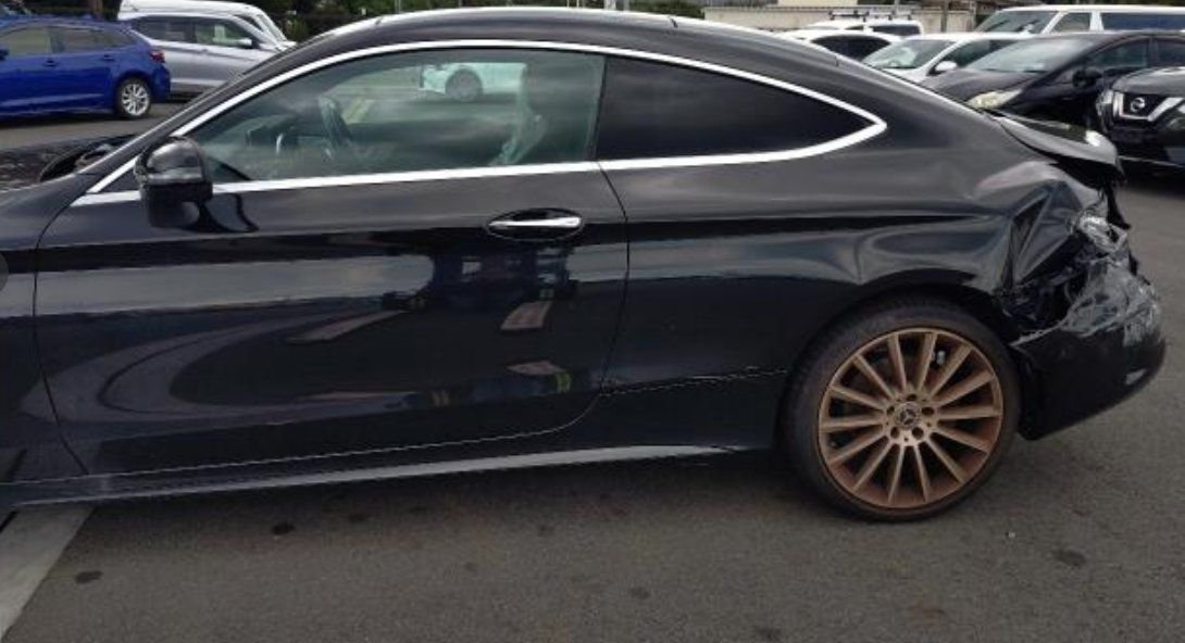Left side of the coupe with damage behind the rear wheel