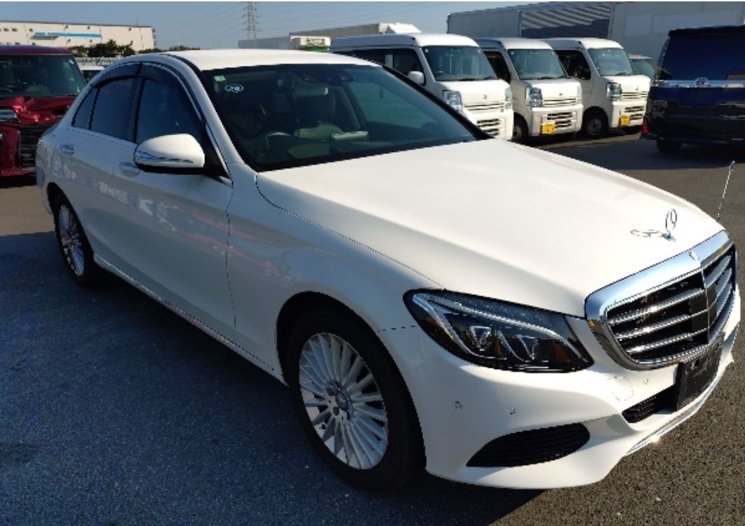 White Mercedes-Benz C200 sedan seen from the front right