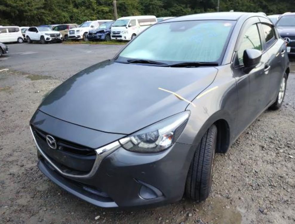 Grey Mazda Demio seen from the front left
