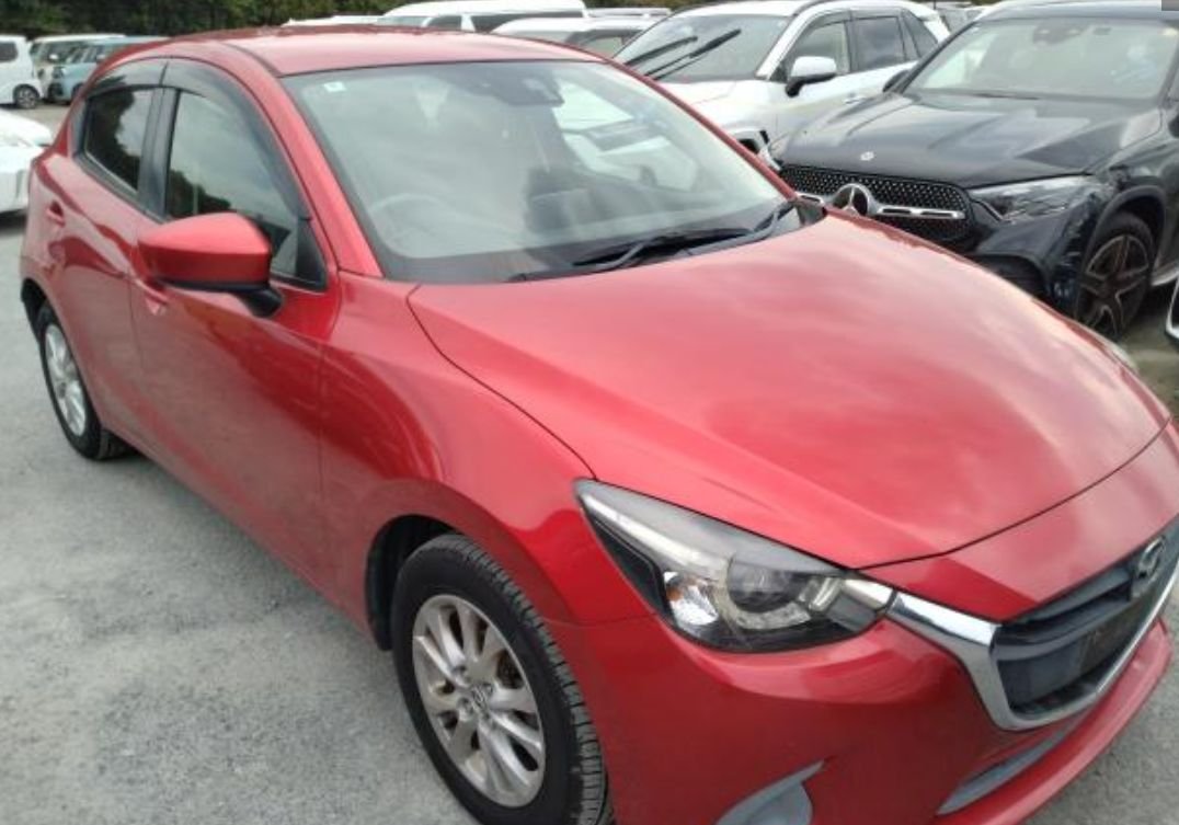 Front right of the red Mazda Demio