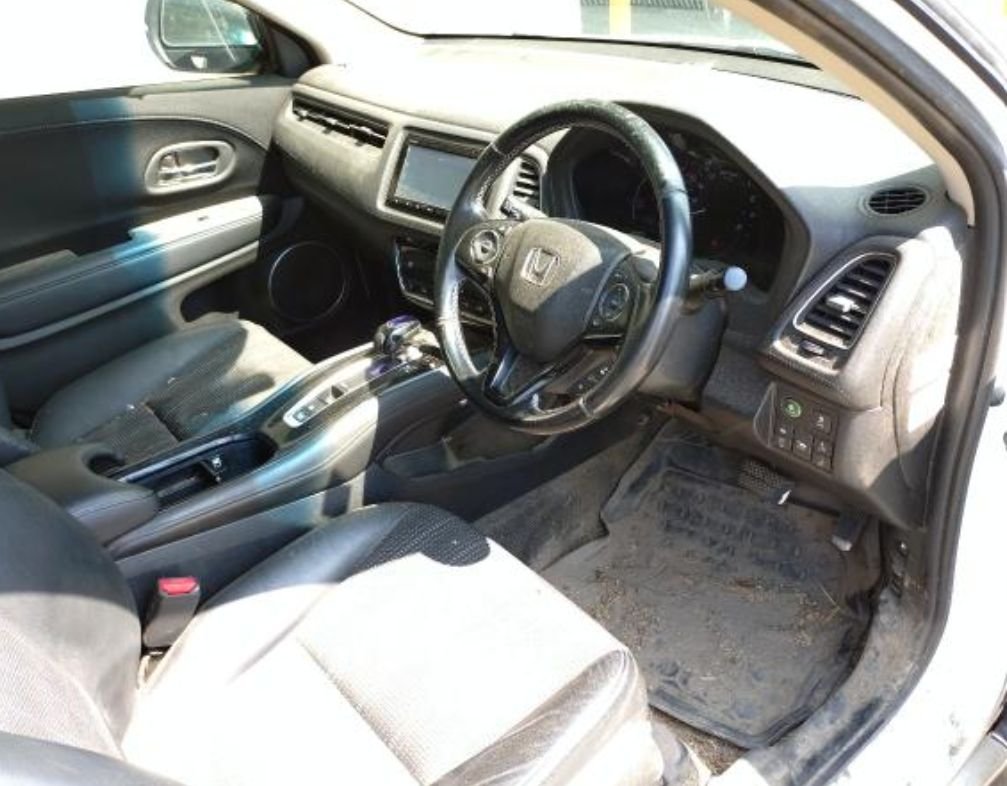 Right-hand-drive interior with dirt on the floor and seats
