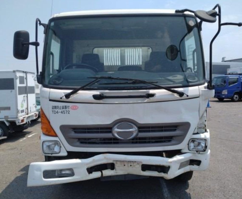 Front of the cab showing the damaged bumper and left headlight area