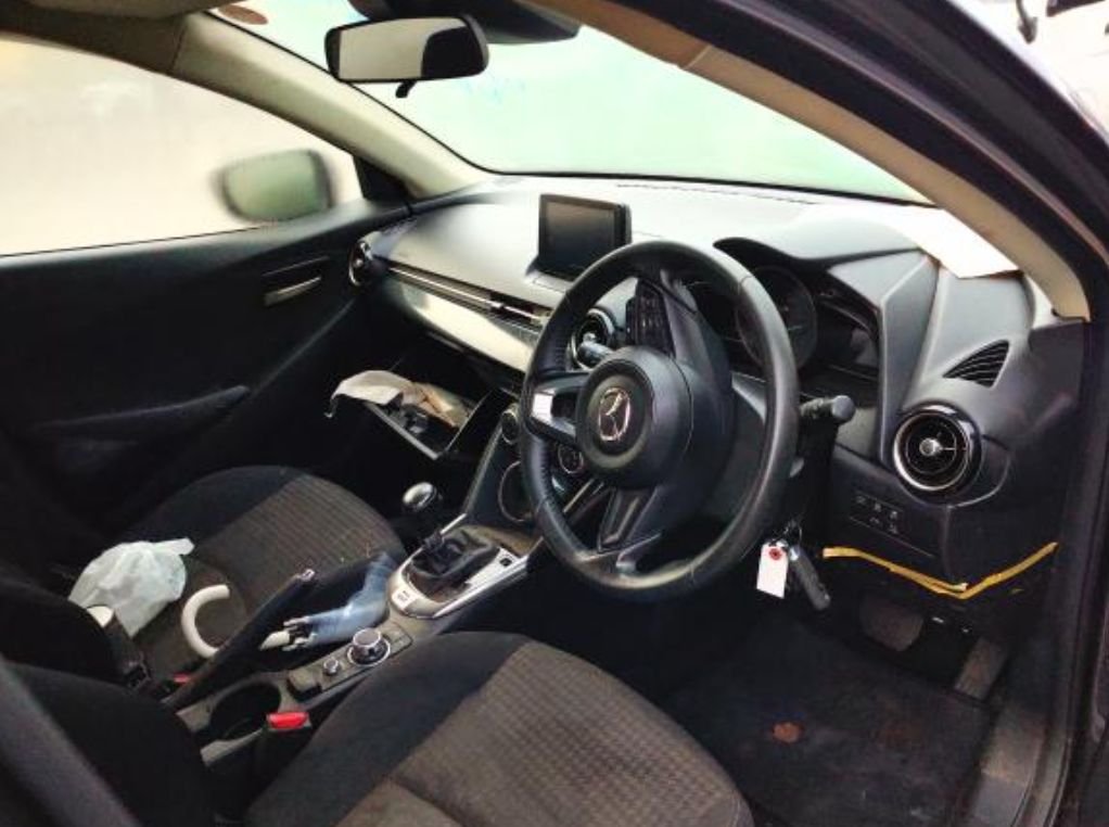 Right-hand-drive interior with a manual gear lever, dirty seats and floor