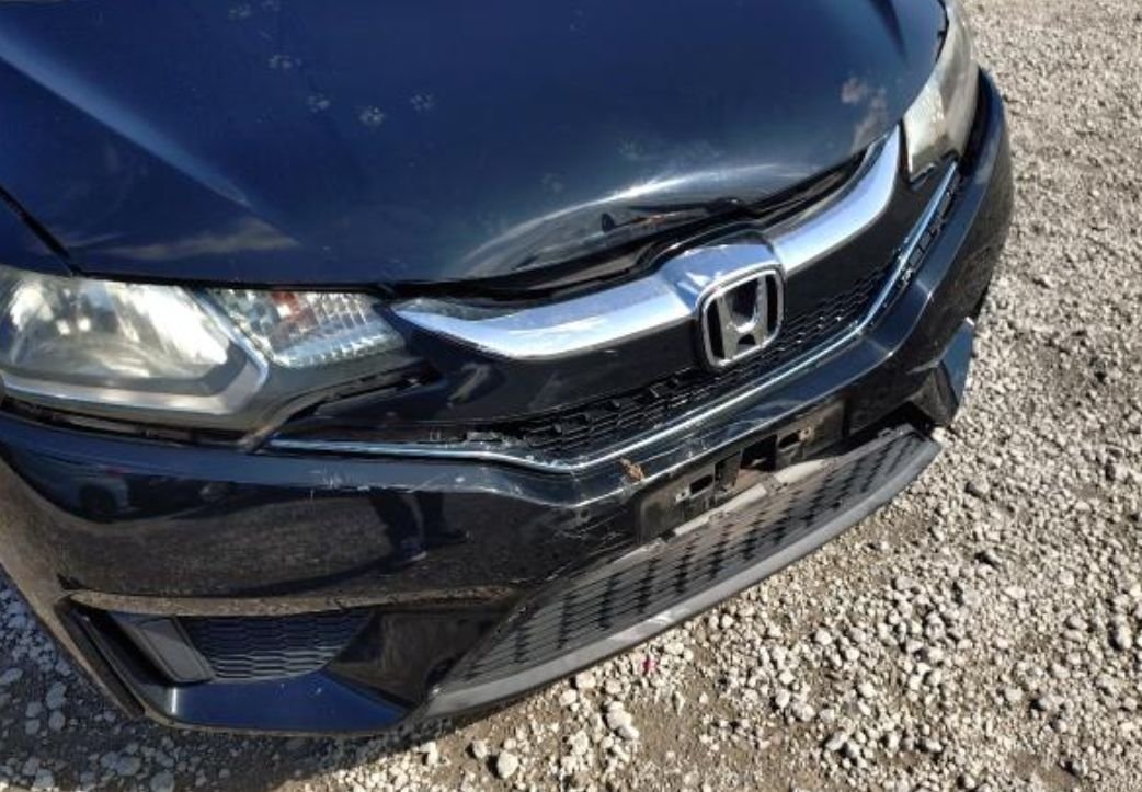 Close-up of the damaged front bumper and grille