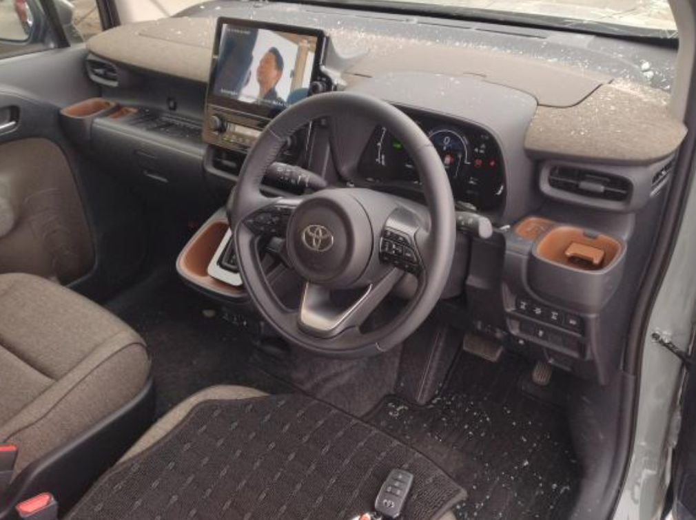 Right-hand-drive dashboard with broken glass on it