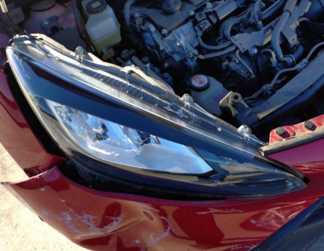 Close-up of the damaged right headlight area