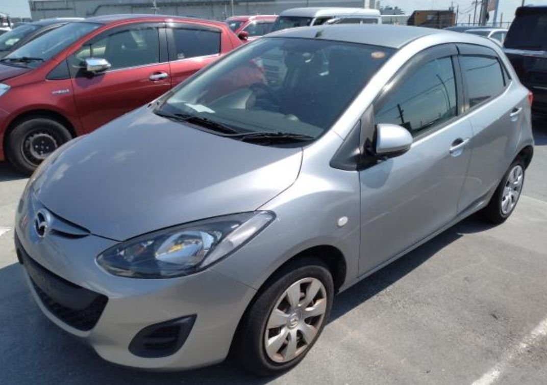Silver Mazda Demio hatchback seen from the front left