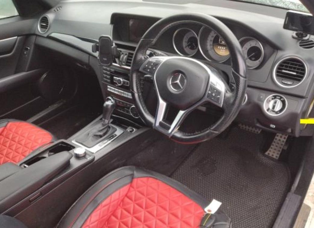 Right-hand-drive cockpit with red and black front seat covers