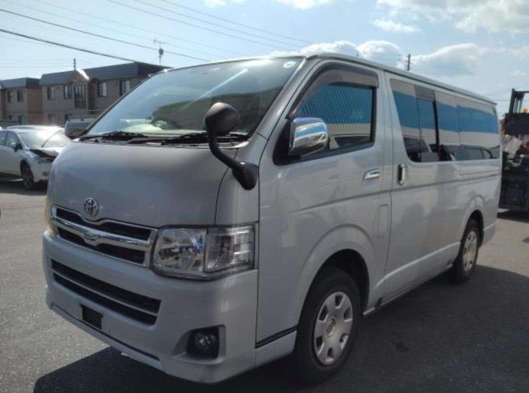 Silver Toyota Hiace van seen from the front left
